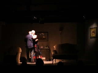 (Image: A Man and a Woman Slow-Dance in a Dimly Lit Reception Room)